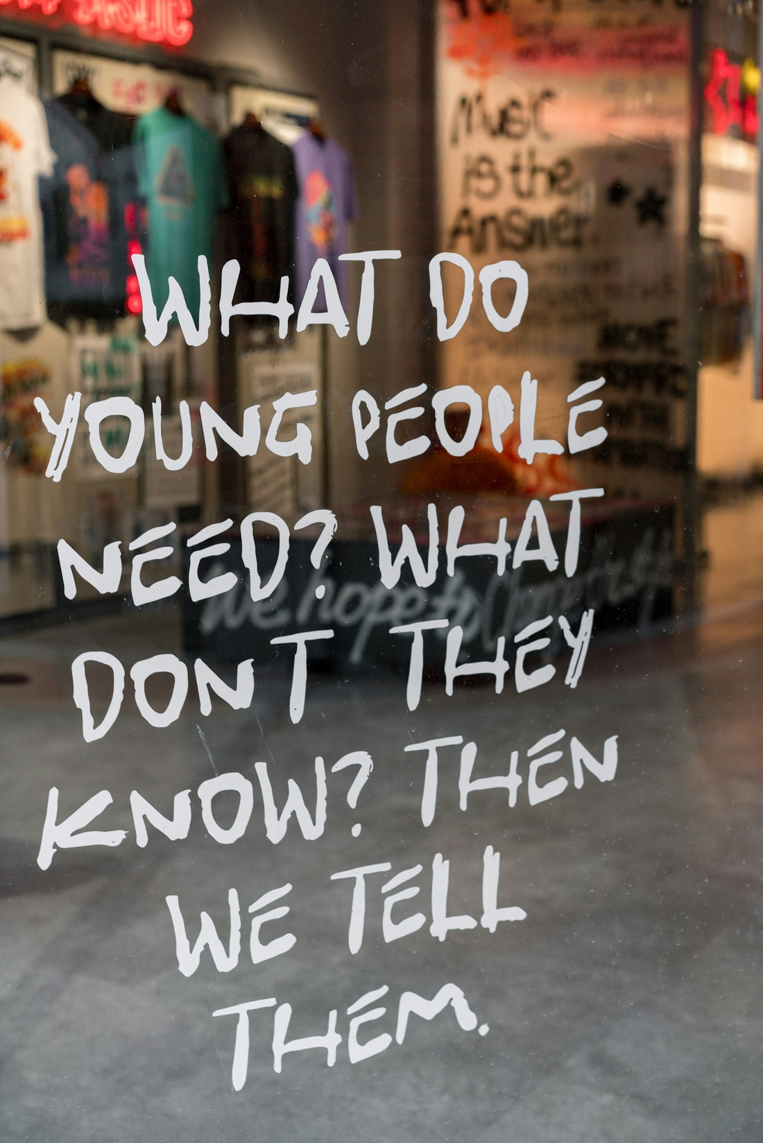A window with a sign that says what do young people need? what don '
